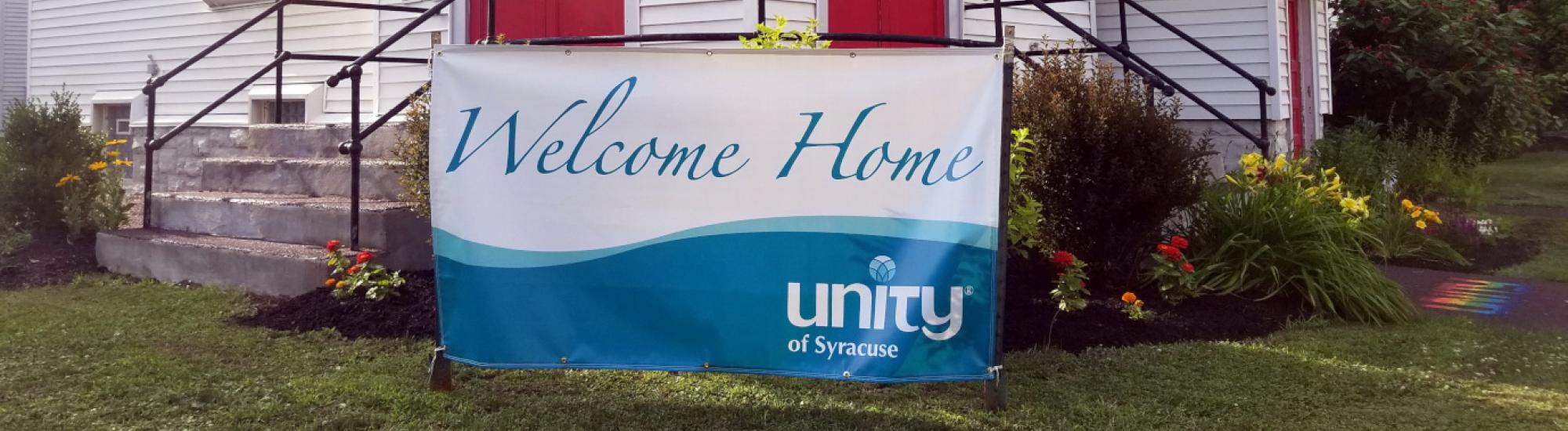 front entrance of the church with a "welcome home; unity of syracuse" banner